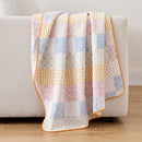 sunday patchwork muslin blanket rainbow patchwork pink blue striped back light grey sofa