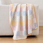 sunday patchwork muslin blanket rainbow patchwork pink blue striped back light grey sofa