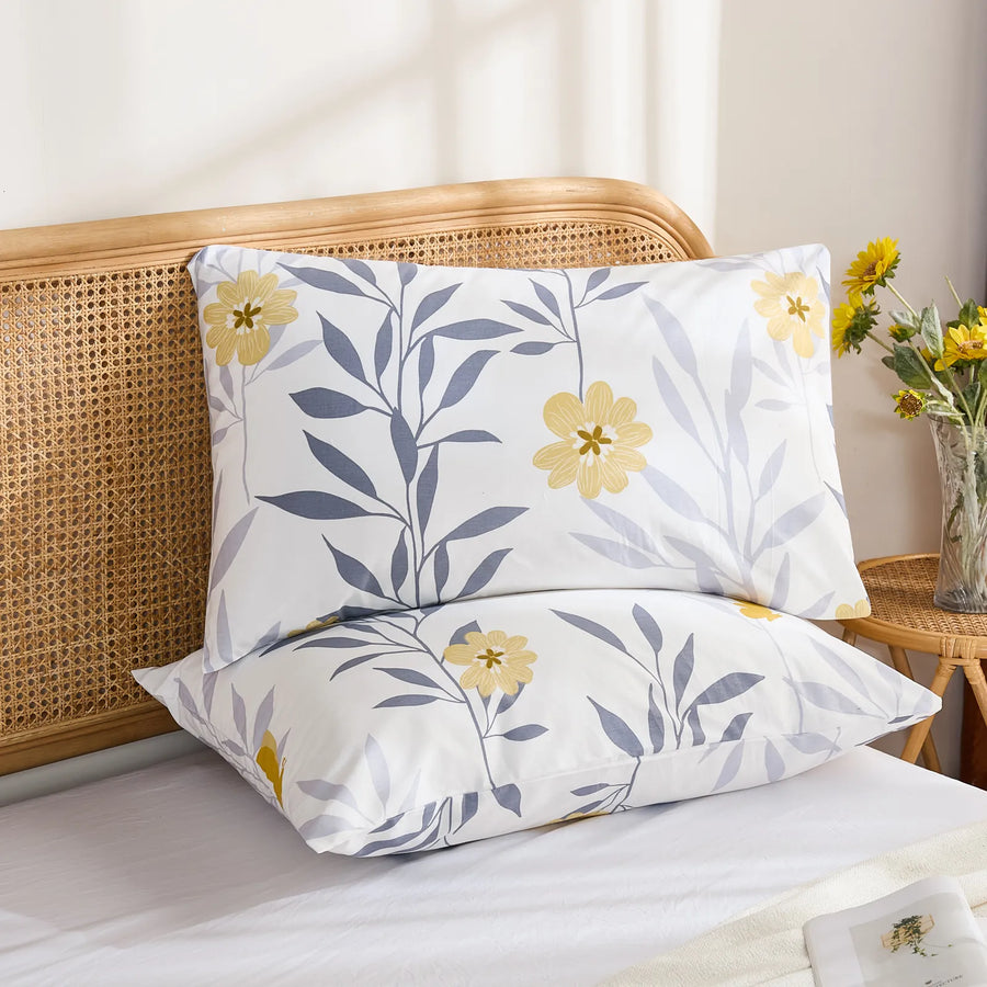 sunlit grey yellow botanical pillowcases stacked bedroom decor