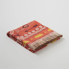 Folded terracotta boho cotton knit throw with tassels and ethnic geometric pattern