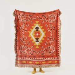 Full view of terracotta boho cotton throw displaying central diamond and arrows motif