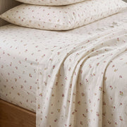 tiny blossom sheet set pillow stack fabric closeup