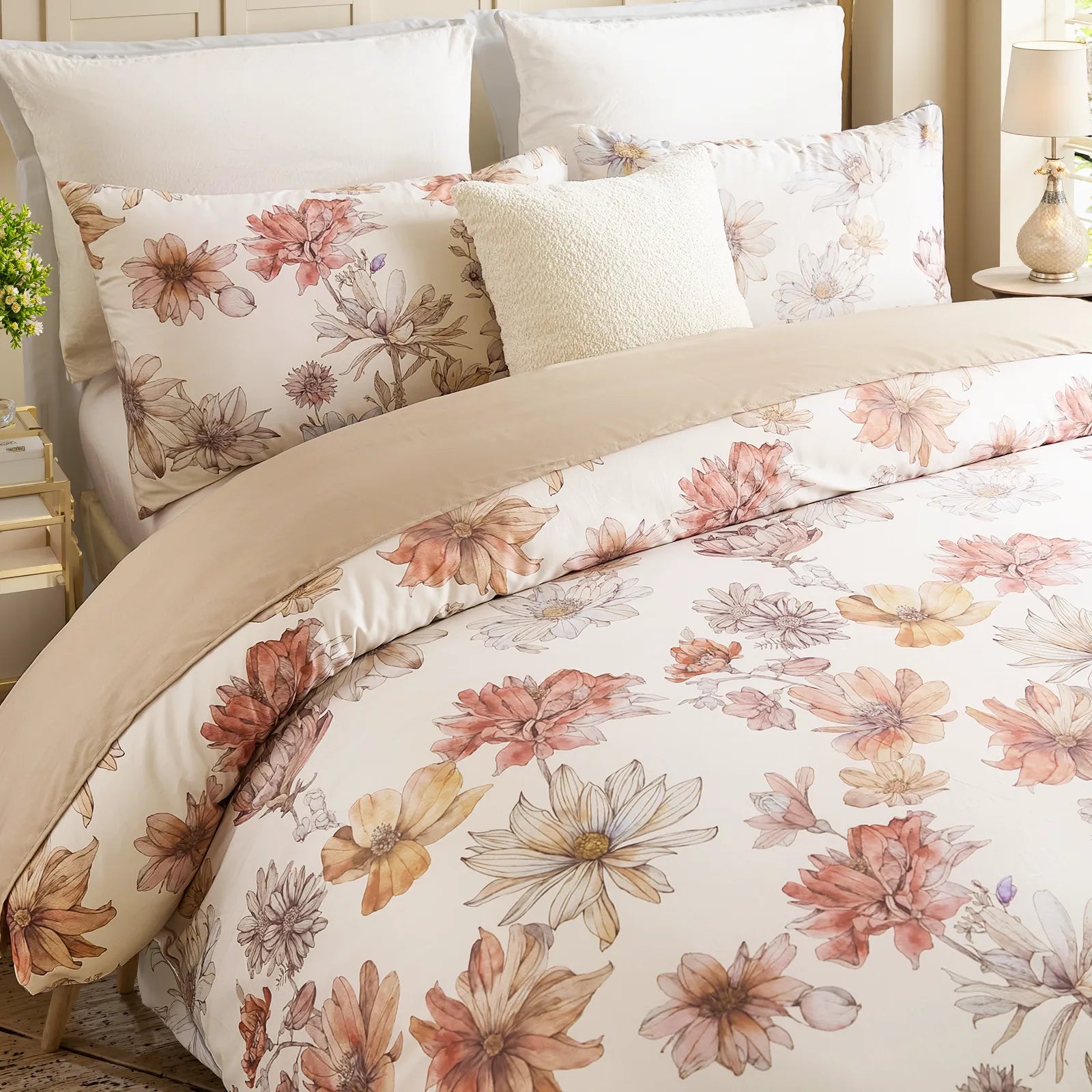 Close-up of vibrant pink orange and red botanical flowers on duvet cover