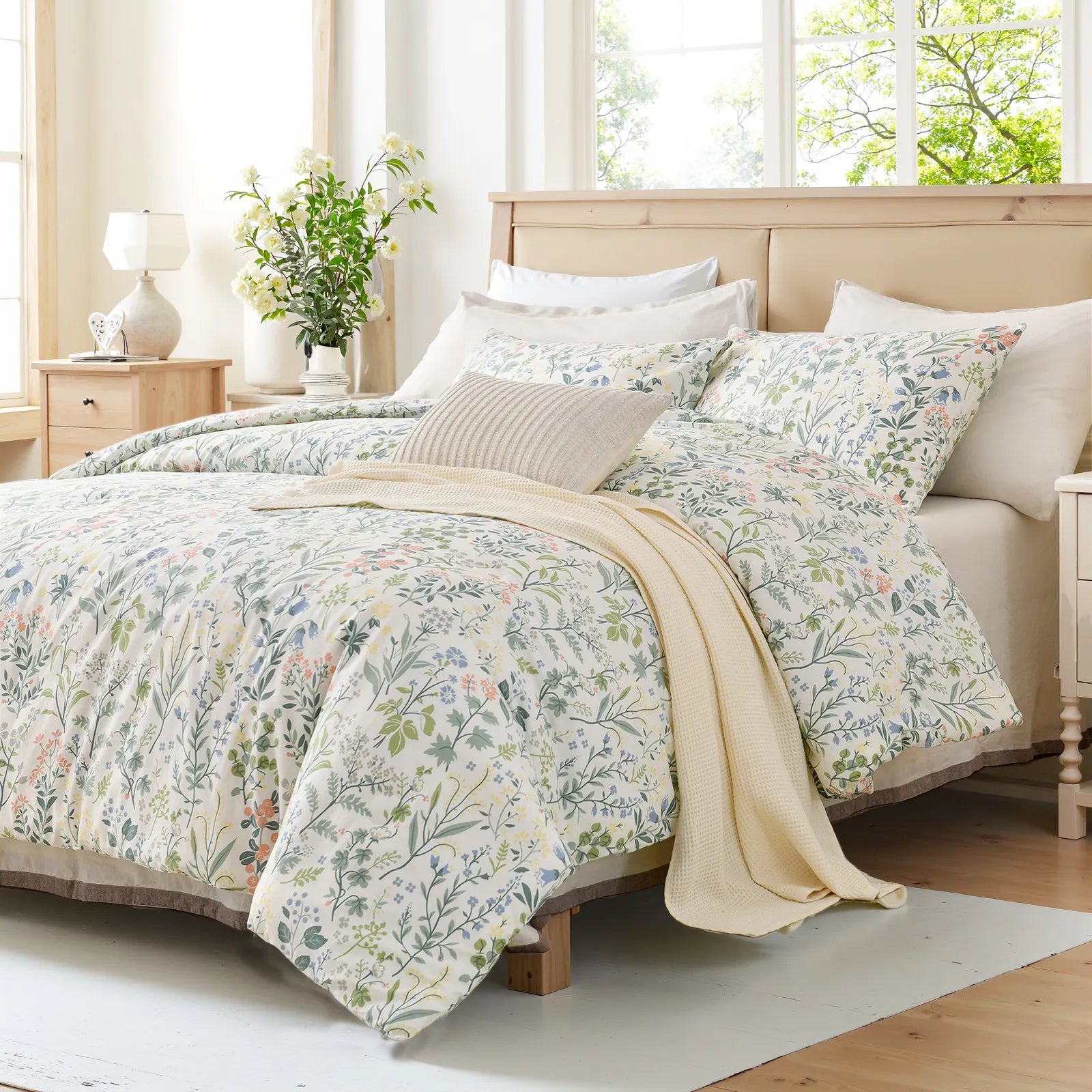 a bed with a vintage green floral comforter and pillows