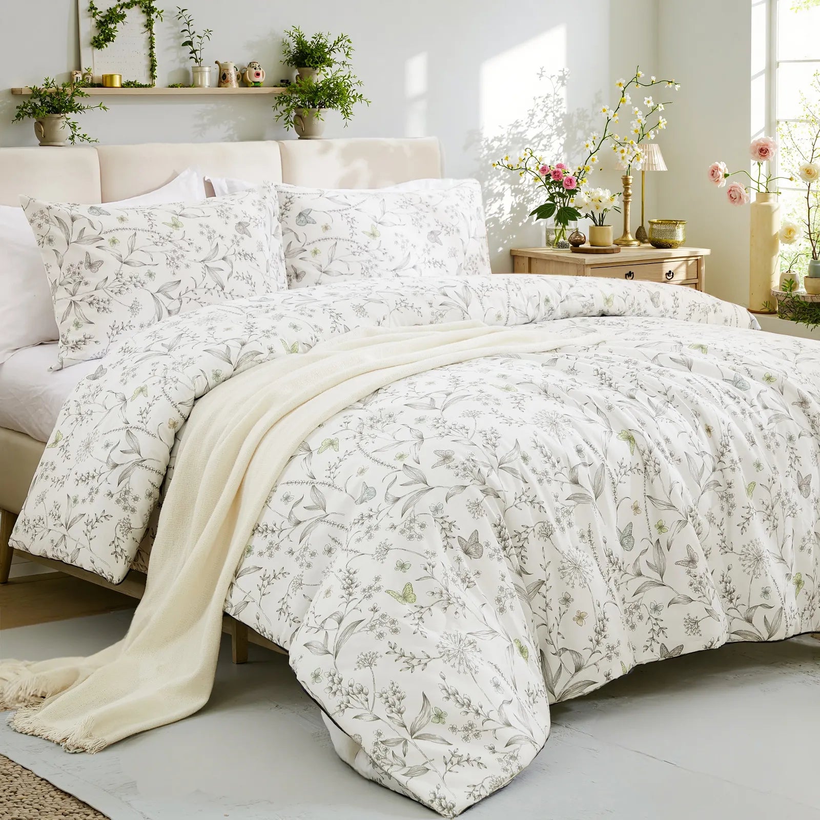 The grey floral duvet cover set on a bed, showing the full design and pillows