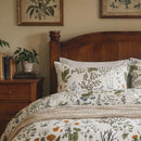 close-up of botanical print cotton pillowcases with wildflower and berry illustrations