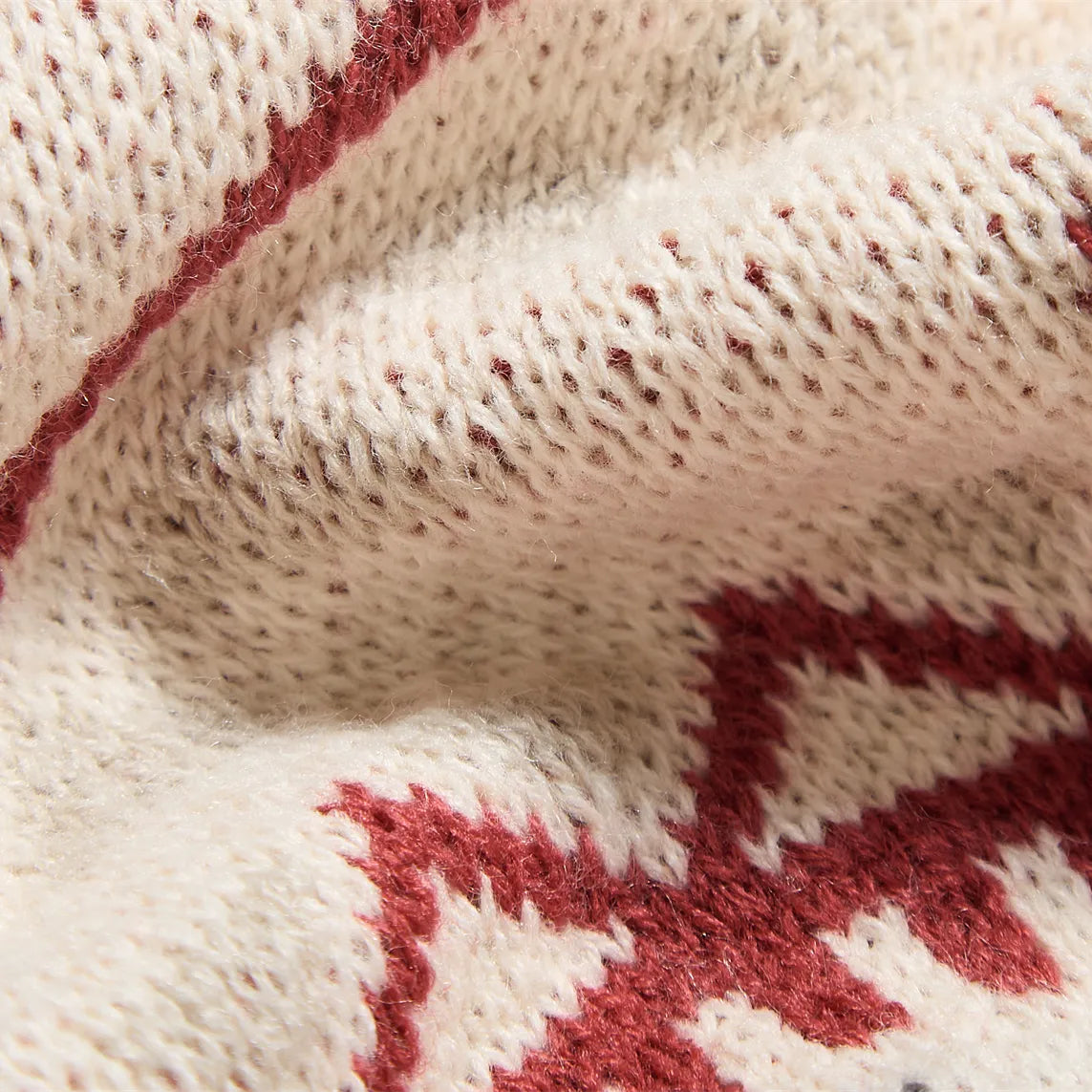 Extreme close up of vintage boho geometric knit blanket texture and material detail