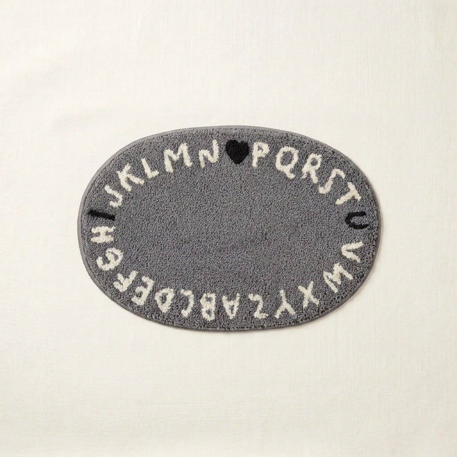 whimsy garden rug abc grey flat lay product photo