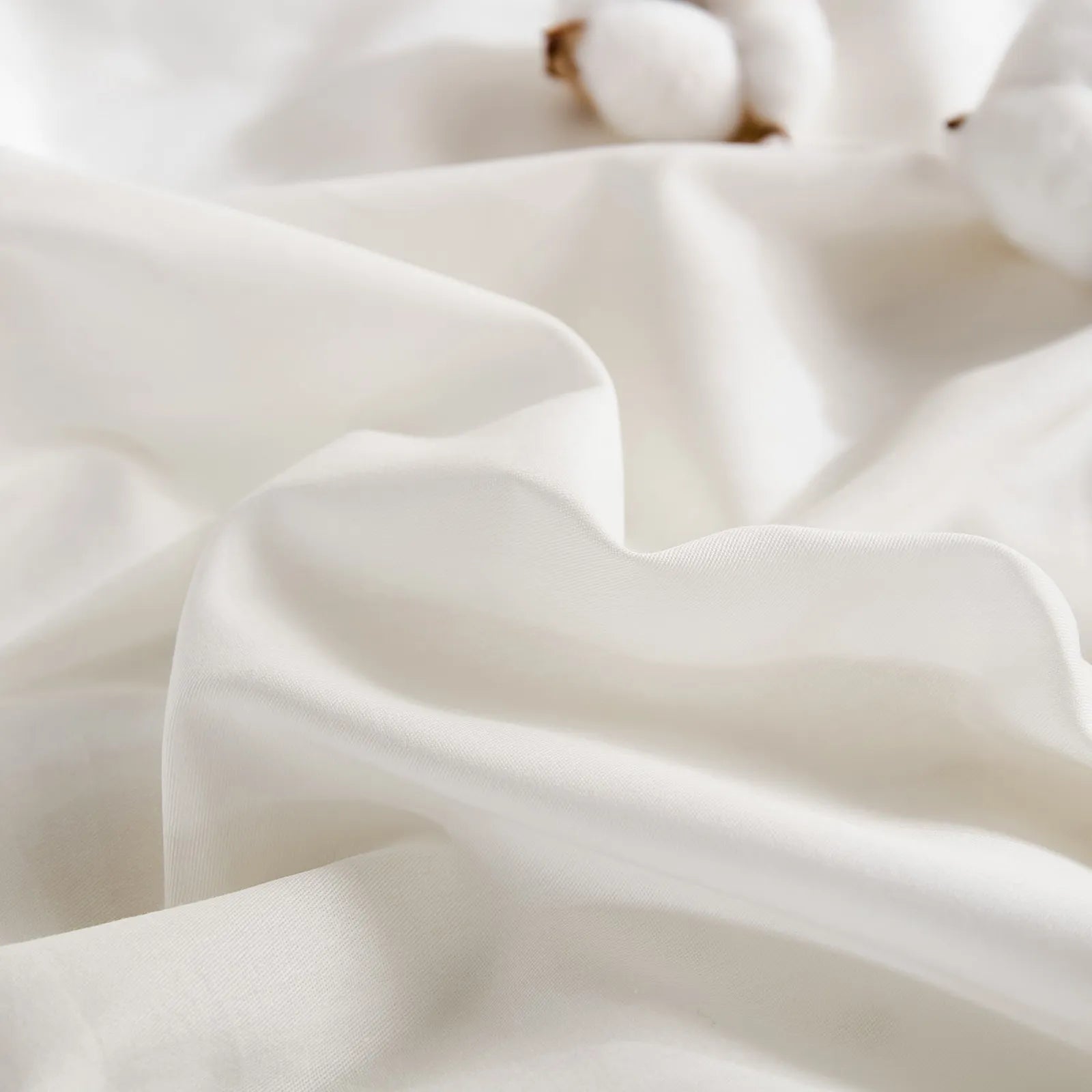 White duvet material detail showing cotton with brown stems