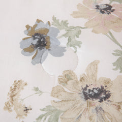 Close-up of the floral pattern on the white comforter fabric.