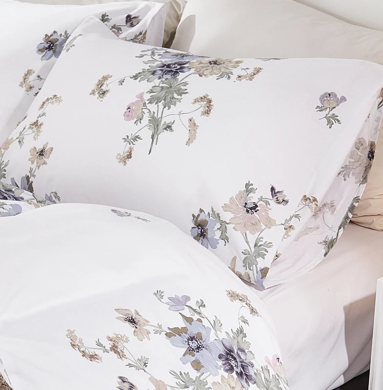 Detailed view of the fabric and floral print on the pillowcases