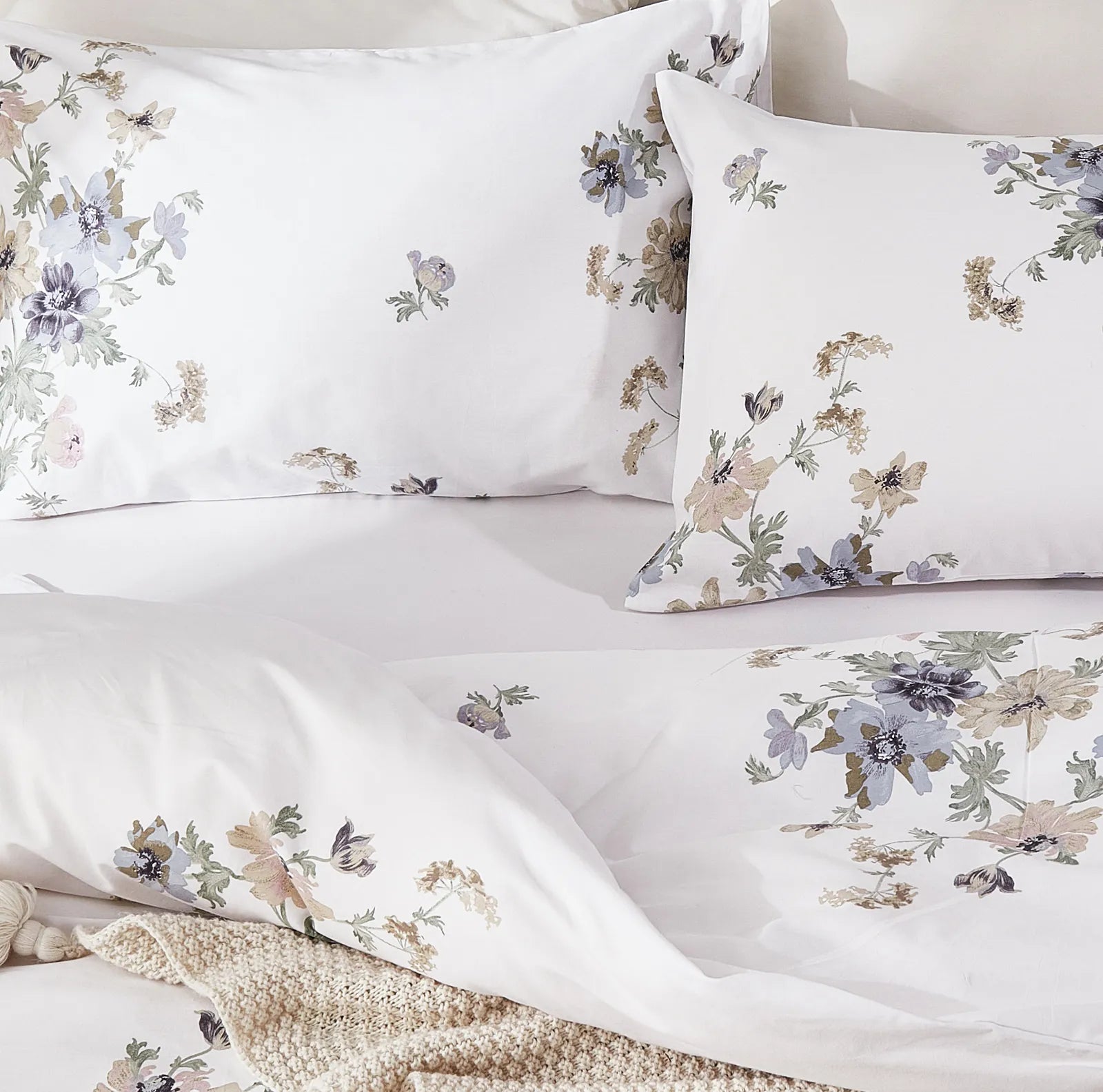 A pair of the white garden floral pillowcases folded for display.