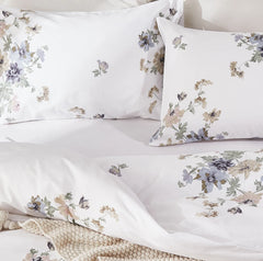 A pair of the white garden floral pillowcases folded for display.