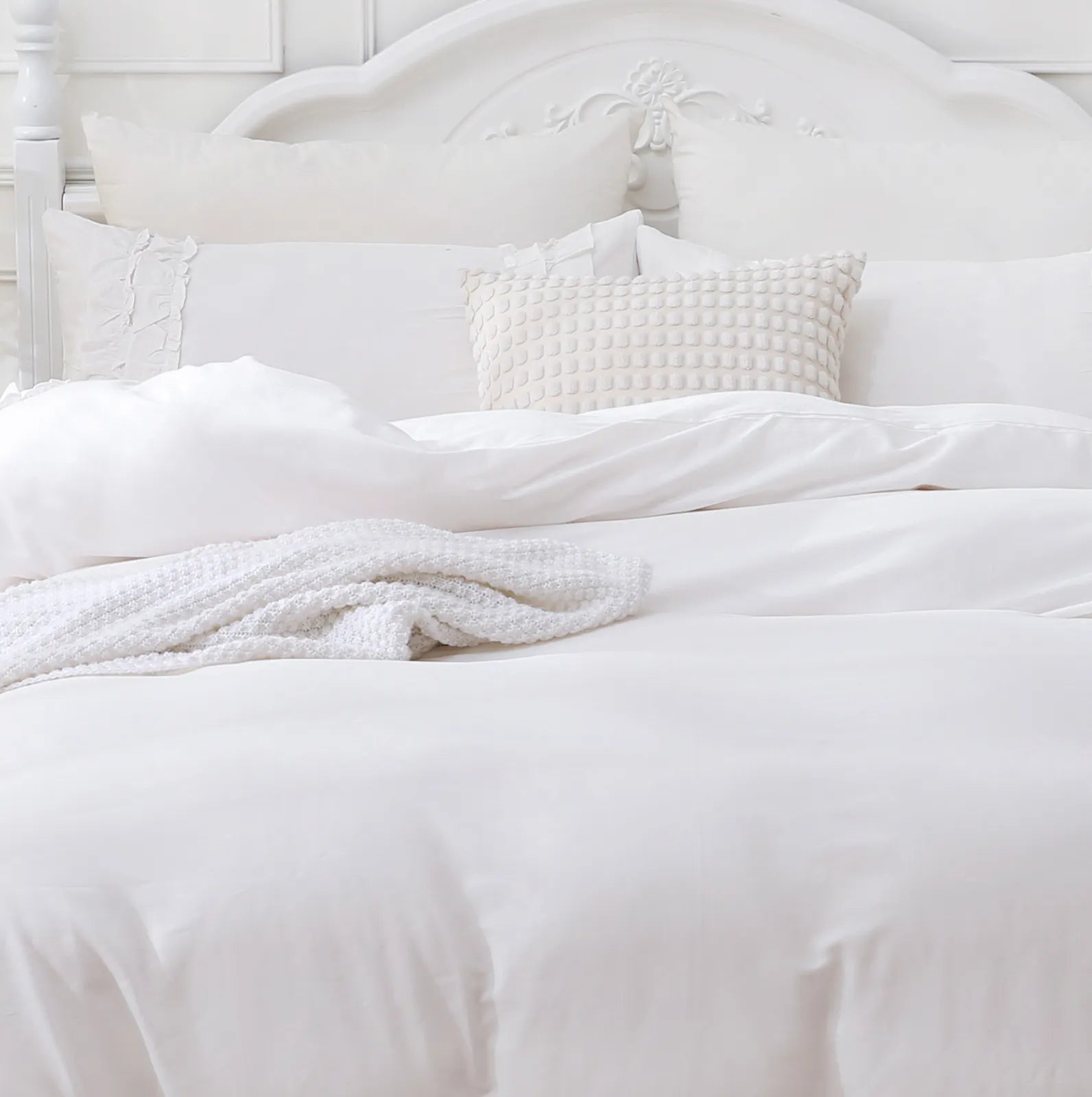 detailed view of the white ruffled comforter set
