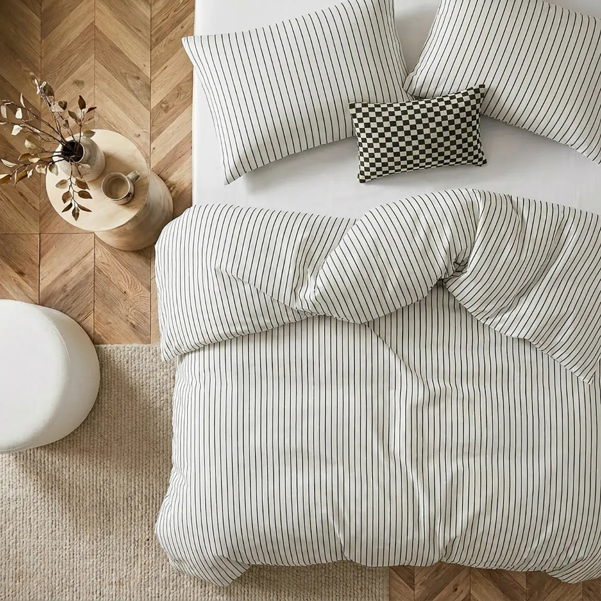 Overhead flat lay of white striped duvet and cases