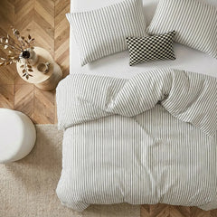 Overhead flat lay of white striped duvet and cases