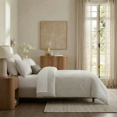 Side view of white striped duvet and pillows