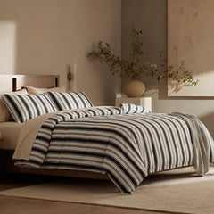 Angled shot of white black grey striped duvet cover on bed