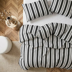 Overhead flat lay of white black grey  striped duvet and cases