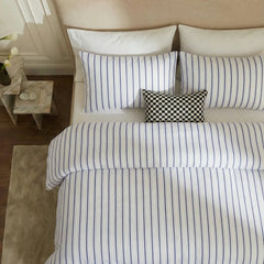 Overhead flat lay of white blue striped duvet and cases