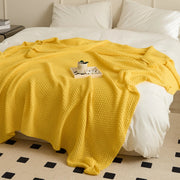 Bright Yellow Knitted Throw Blanket Draped on Bed with Tray Decor