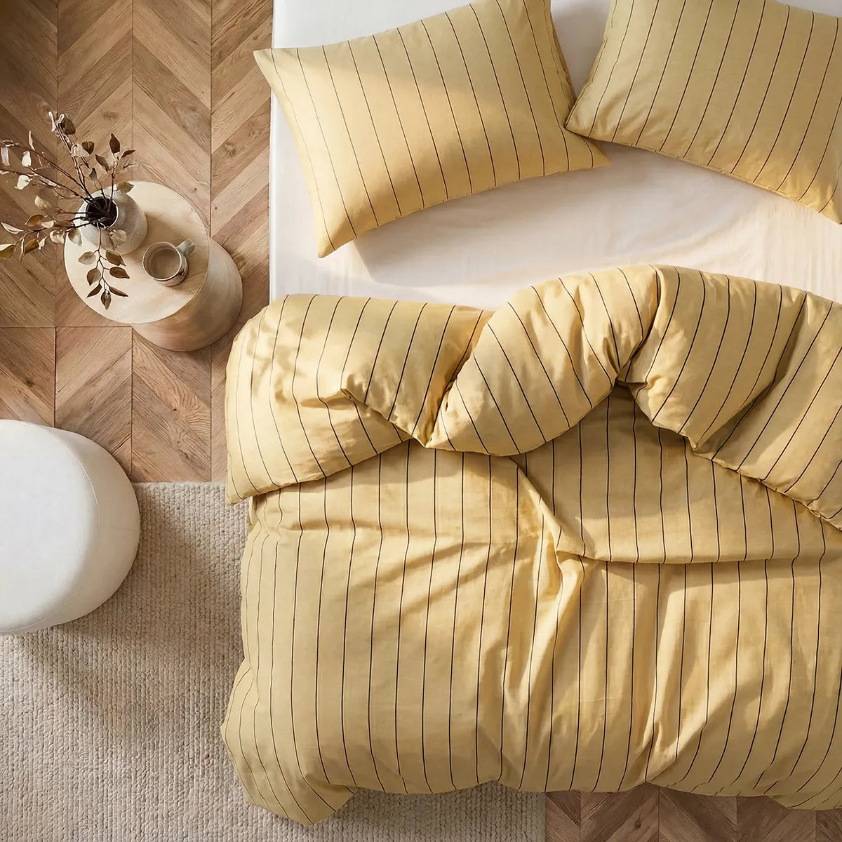 Overhead flat lay of yellow striped duvet and cases