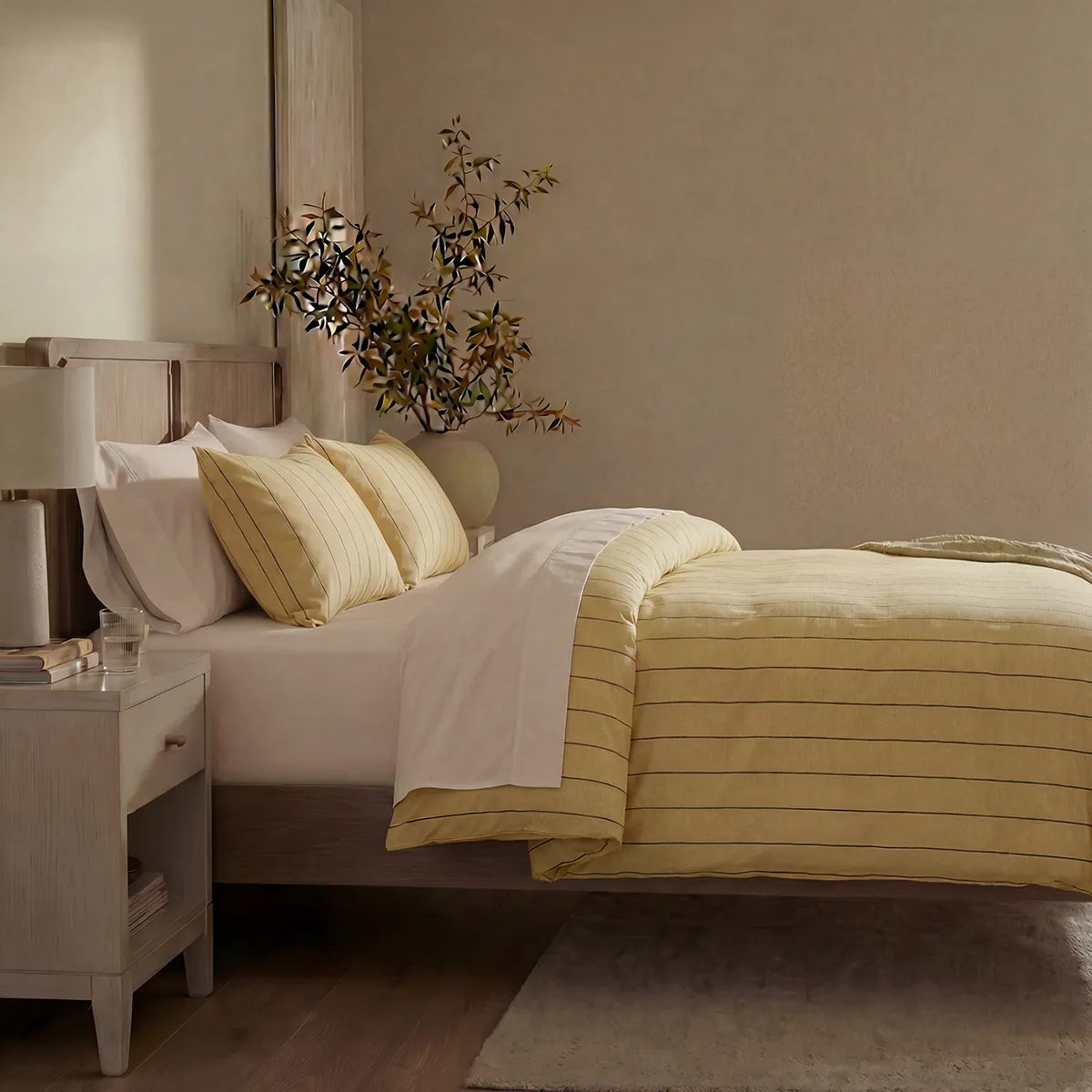 Side view of yellow striped duvet and pillows